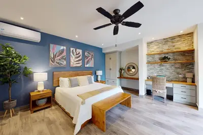 a bedroom with a bed and a ceiling fan at Private Pool with swim up bar and TWO Beaches in Tamarindo