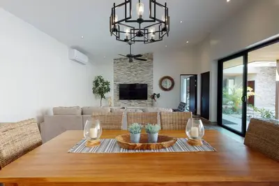 a living room with a table and a couch at Private Pool with swim up bar and TWO Beaches in Tamarindo