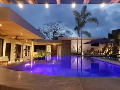 a swimming pool in a house with purple lighting at Private Pool with swim up bar and TWO Beaches in Tamarindo