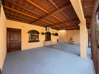an empty garage with a wooden ceiling and a door at Posada Florencia AC near Guanacaste Airport in Liberia
