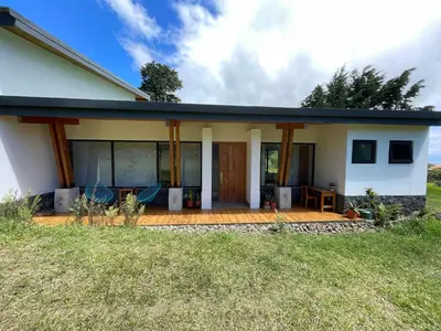 a home with a porch and a patio at Aires de Quetzales in Concepción