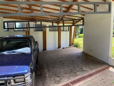 a car parked in a garage with a roof at Aires de Quetzales in Concepción