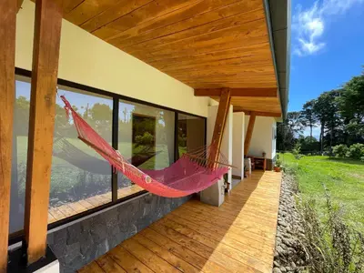 a hammock on the porch of a house at Aires de Quetzales in Concepción