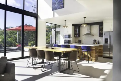 a kitchen and dining room with a wooden table and chairs at Prime Hermosa- Ocean View Villa with Infinity Pool in Playa Hermosa