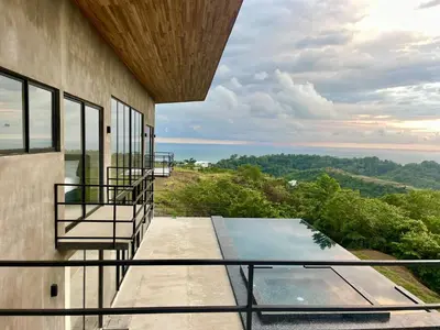 a view from the balcony of a house with a swimming pool at Prime Hermosa- Ocean View Villa with Infinity Pool in Playa Hermosa