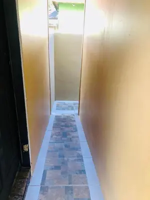 a hallway with a wall and a tile floor at Freddy`s Place B&B in Monteverde Costa Rica