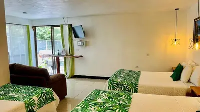 a hotel room with two beds and a television at Freddy`s Place B&B in Monteverde Costa Rica