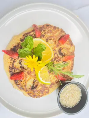 a white plate topped with a meal of food with a flower on it at Freddy`s Place B&B in Monteverde Costa Rica