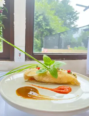 a white plate with a sandwich on a table at Freddy`s Place B&B in Monteverde Costa Rica