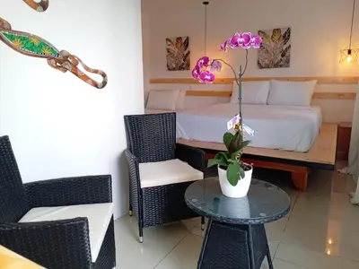 a bedroom with a bed and a table and chairs at Freddy`s Place B&B in Monteverde Costa Rica