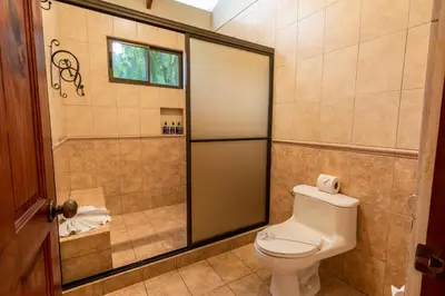 a bathroom with a toilet and a shower at Hotel El Silencio del Campo in Fortuna