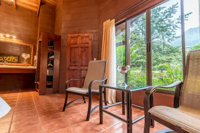 a room with a table and chairs and a window at Hotel El Silencio del Campo in Fortuna
