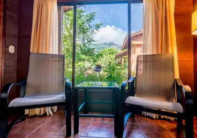 two chairs and a table in front of a window at Hotel El Silencio del Campo in Fortuna