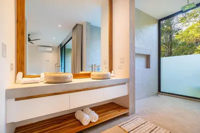 a bathroom with two sinks and a large mirror at Casa Colibri - by Pura Villas in Uvita