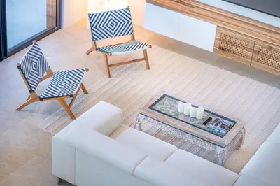 a living room with a white couch and two chairs at Casa Colibri - by Pura Villas in Uvita