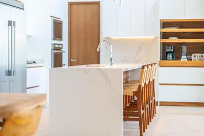 a kitchen with a white counter with a sink at Casa Colibri - by Pura Villas in Uvita