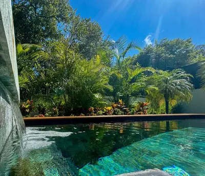 a swimming pool in a yard with palm trees at Private Pool with direct access to 2 beaches! in Tamarindo