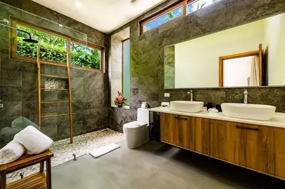 a bathroom with two sinks and a shower at Private Pool with direct access to 2 beaches! in Tamarindo