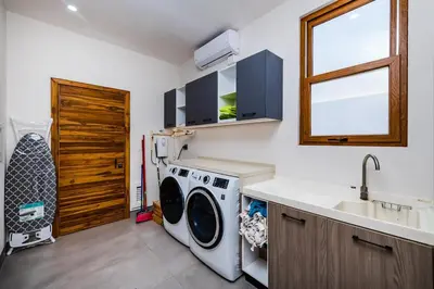 a kitchen with a washing machine and a sink at Private Pool with direct access to 2 beaches! in Tamarindo