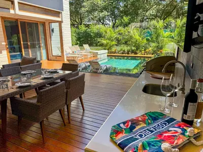 a patio with a table and chairs and a pool at Private Pool with direct access to 2 beaches! in Tamarindo