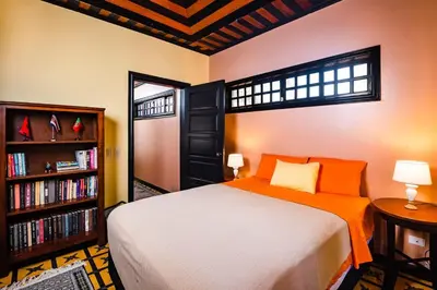 a bedroom with a bed and a book shelf at Luxury Villa With Beach Access and a Private Pool in Tamarindo