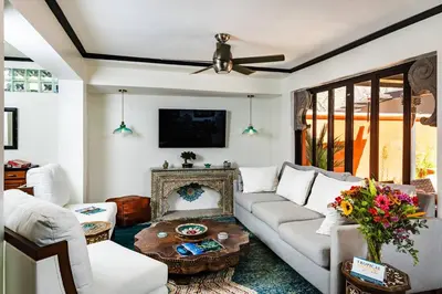 a living room with a white couch and a table at Luxury Villa With Beach Access and a Private Pool in Tamarindo