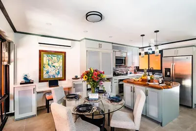 a kitchen with a glass table and chairs in it at Luxury Villa With Beach Access and a Private Pool in Tamarindo