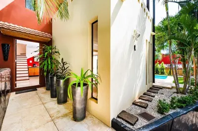 a house with a courtyard with potted plants at Private pool BBQ, Fast Wifi Alarm Close to Beach in Tamarindo