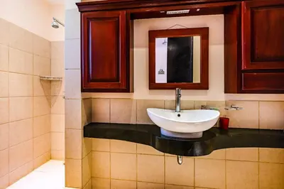 a bathroom with a sink and a mirror at Private pool BBQ, Fast Wifi Alarm Close to Beach in Tamarindo