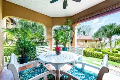 a patio with a table and chairs on a porch at Light & Breezy Beach Side Condo! in Tamarindo