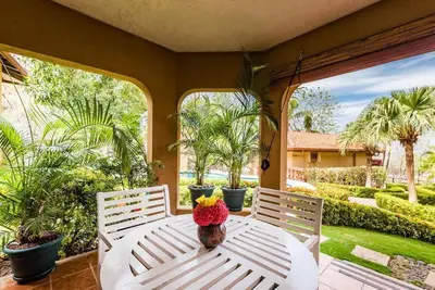 a stuffed animal sitting on a white table on a porch at Light & Breezy Beach Side Condo! in Tamarindo