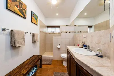 a bathroom with a sink and a toilet at Light & Breezy Beach Side Condo! in Tamarindo