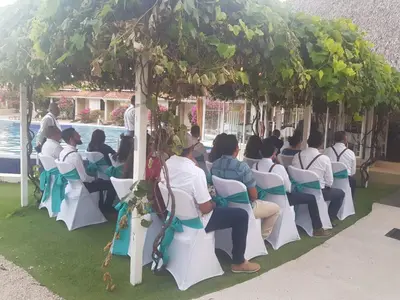 a group of people sitting in chairs under a gazebo at Seis Playas Hotel in Tamarindo