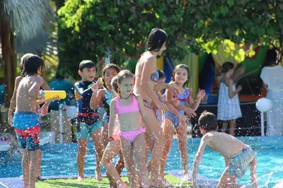 a group of children playing in the water at a pool at Seis Playas Hotel in Tamarindo