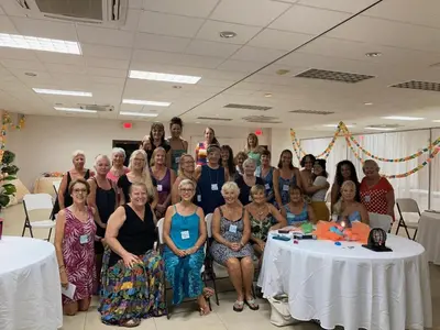 a group of people posing for a picture in a room at Seis Playas Hotel in Tamarindo