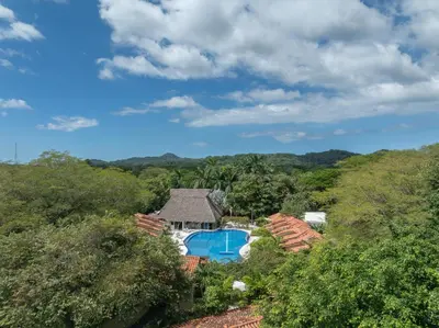 an aerial view of a house with a swimming pool at Seis Playas Hotel in Tamarindo