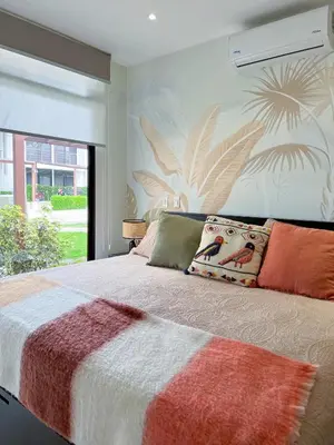 a bedroom with a bed with a large window at Exclusive fully equipped Condo with great pool in Jacó