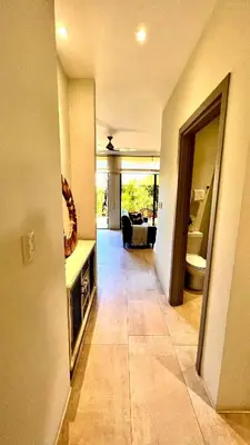 a hallway of a house with a living room at Exclusive fully equipped Condo with great pool in Jacó