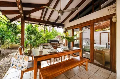 a dining room with a table and chairs at Newly Remodeled Villa Across from the beach in Tamarindo