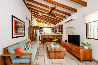 a living room with a couch and a tv at Newly Remodeled Villa Across from the beach in Tamarindo