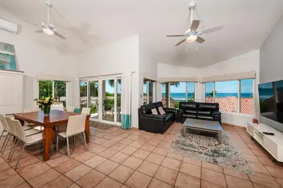 a living room with a dining room table and chairs at Beautiful 3 Bedroom Condo with Ocean Views in Tamarindo