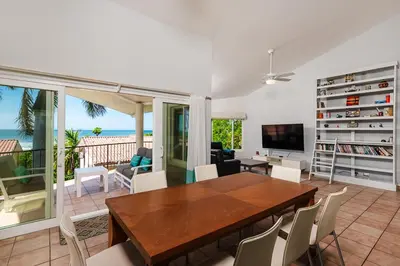 a living room with a wooden table and chairs at Beautiful 3 Bedroom Condo with Ocean Views in Tamarindo