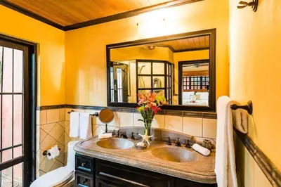 a bathroom with two sinks and a mirror at Luxury Villa, near the Beach with a Private Pool in Tamarindo