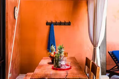 a dining room with a wooden table with fruit on it at Luxury Villa, near the Beach with a Private Pool in Tamarindo