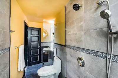 a bathroom with a toilet and a shower at Luxury Villa, near the Beach with a Private Pool in Tamarindo