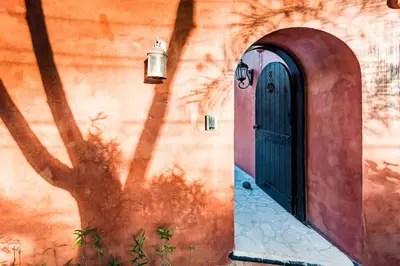 a door to a building with a tree next to it at Luxury Villa, near the Beach with a Private Pool in Tamarindo