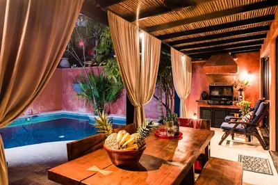 a dining room with a table and a swimming pool at Luxury Villa, near the Beach with a Private Pool in Tamarindo
