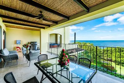 a patio with a glass table and chairs and the ocean at Beachfront Oceanview Private Jacuzzi & Full ktcn in Tamarindo