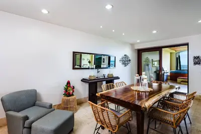 a dining room with a table and chairs and a couch at Beachfront Oceanview Private Jacuzzi & Full ktcn in Tamarindo