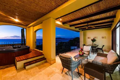 a patio with a hot tub and a table and chairs at Beachfront Oceanview Private Jacuzzi & Full ktcn in Tamarindo